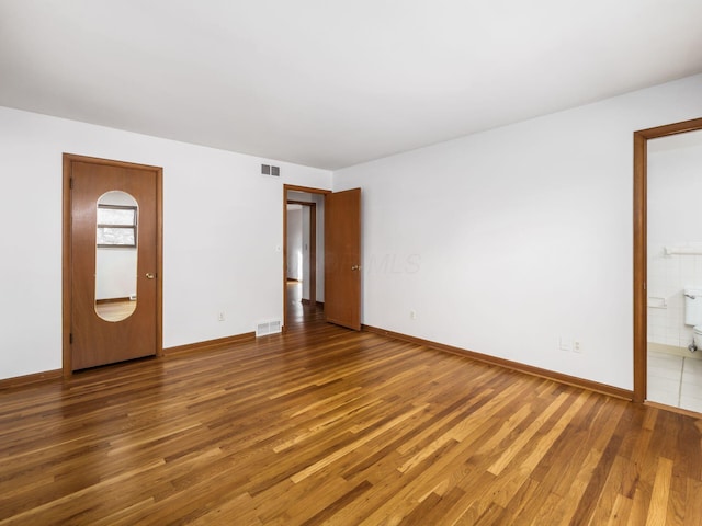 interior space featuring ensuite bathroom and hardwood / wood-style floors