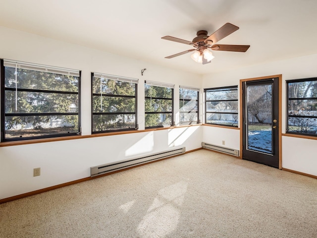 carpeted empty room with a baseboard heating unit and ceiling fan