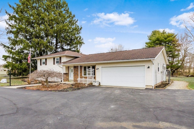 tri-level home featuring brick siding, driveway, and an attached garage