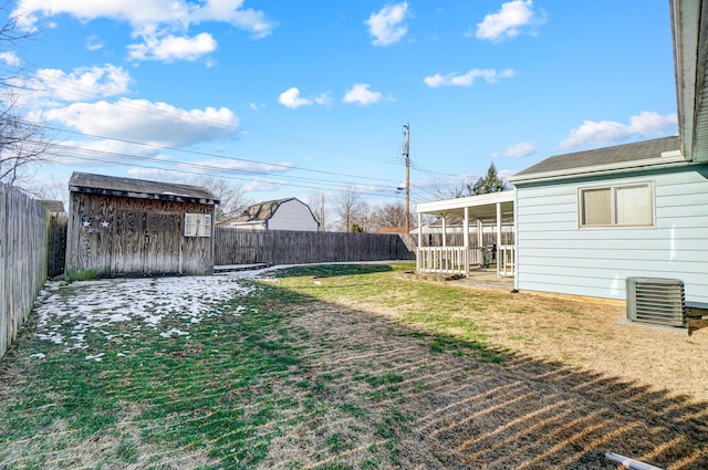 view of yard with central AC unit and a storage unit