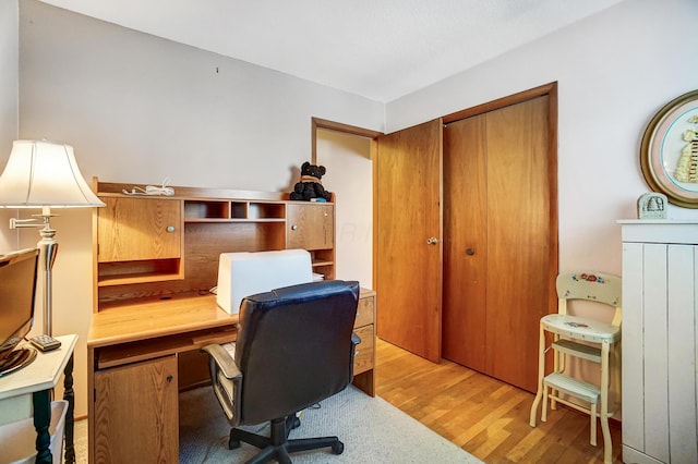 home office with light hardwood / wood-style floors