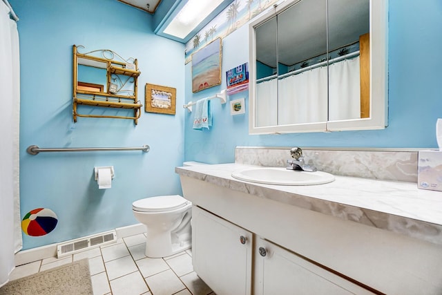 bathroom with vanity, tile patterned floors, and toilet