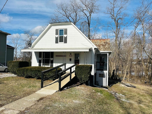 bungalow-style home with a front yard and a porch