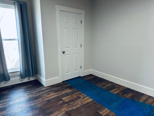 unfurnished room featuring dark hardwood / wood-style flooring