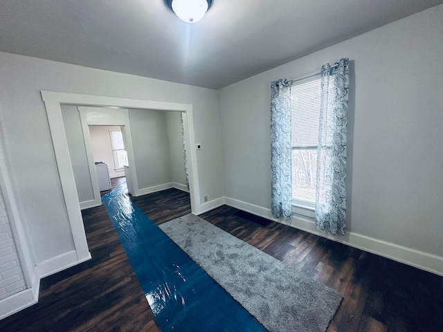 interior space with plenty of natural light and dark hardwood / wood-style floors