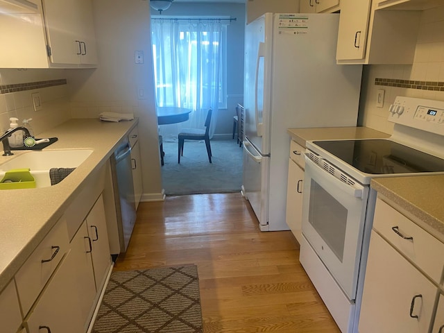 kitchen featuring sink, light hardwood / wood-style flooring, white range with electric stovetop, white cabinets, and stainless steel dishwasher