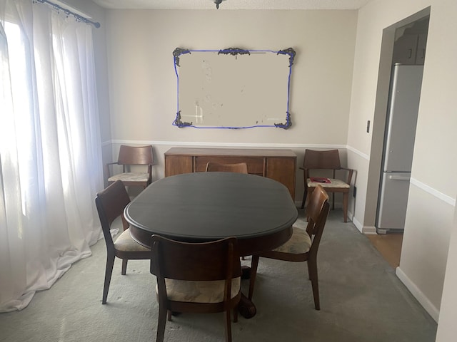 dining room with carpet and a textured ceiling