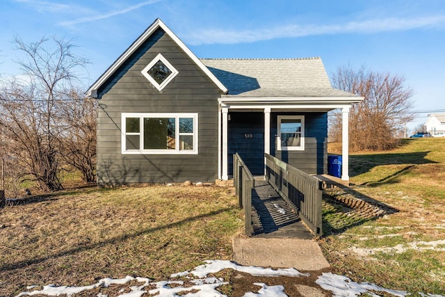 bungalow-style home with a front lawn