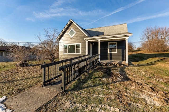 view of front of house with a front lawn and a porch