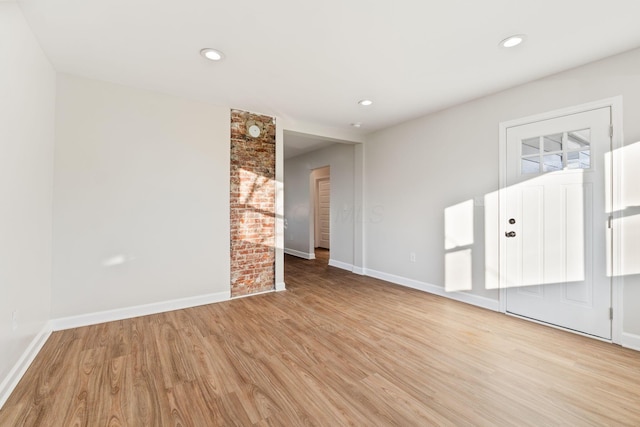 spare room with light wood-type flooring, baseboards, and recessed lighting