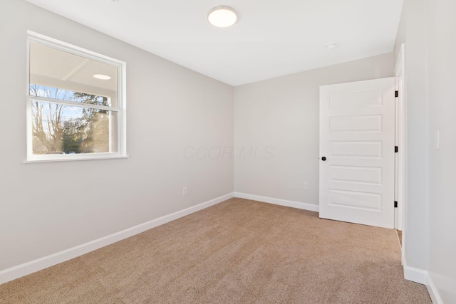 empty room with carpet floors and baseboards