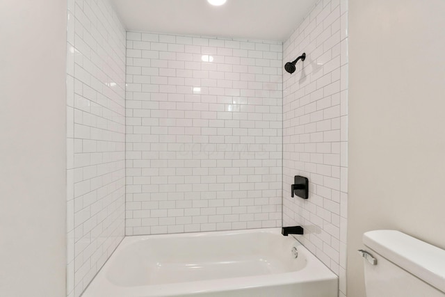 bathroom featuring shower / washtub combination and toilet