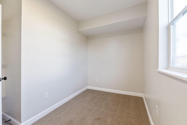 carpeted spare room with baseboards