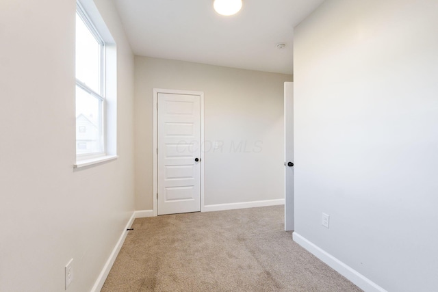 hall with carpet and baseboards