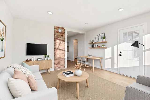 living room featuring baseboards, wood finished floors, and recessed lighting