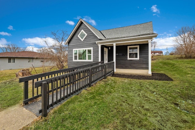 rear view of property featuring a yard