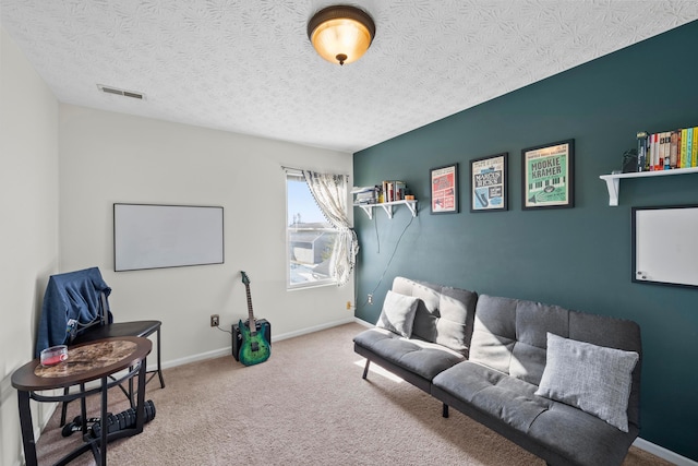 living area featuring carpet floors and a textured ceiling