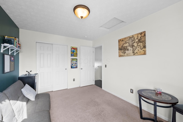 interior space featuring carpet floors and a textured ceiling