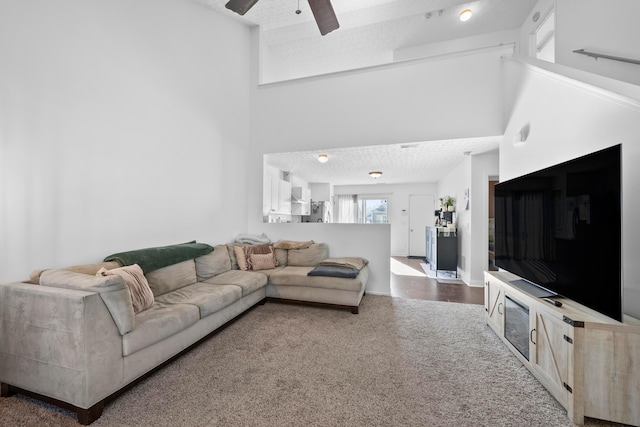 carpeted living room featuring ceiling fan