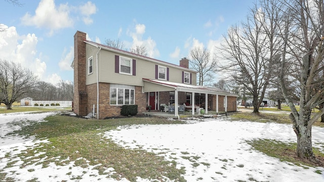 view of front property featuring covered porch and a lawn