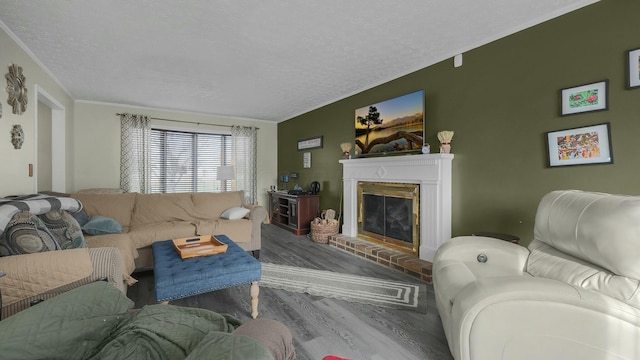 living room with hardwood / wood-style flooring, a fireplace, and a textured ceiling