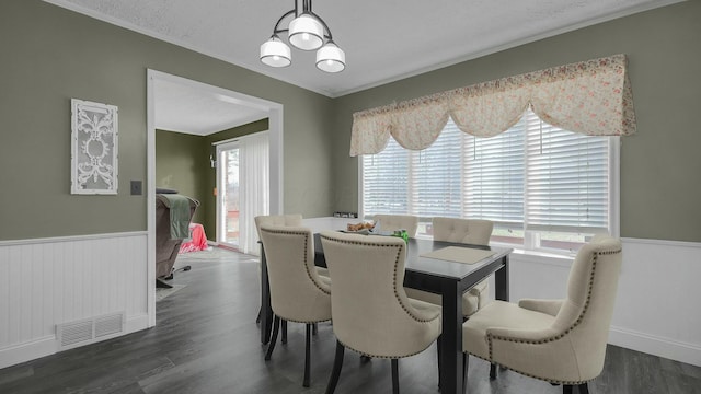 dining space featuring dark hardwood / wood-style flooring and a chandelier