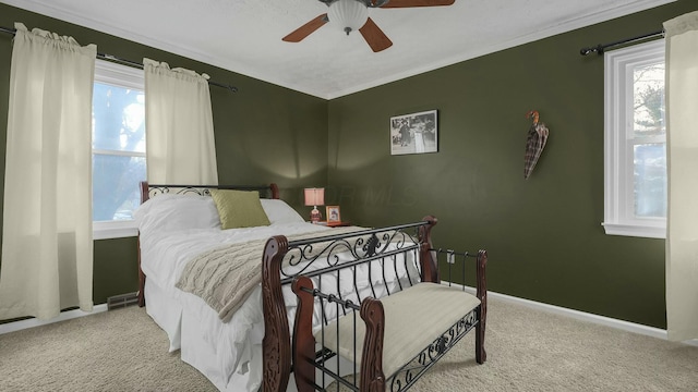 bedroom with carpet floors, ornamental molding, and ceiling fan