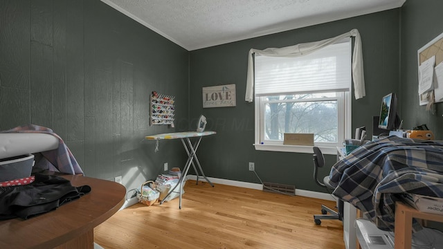 office space with a textured ceiling and light wood-type flooring