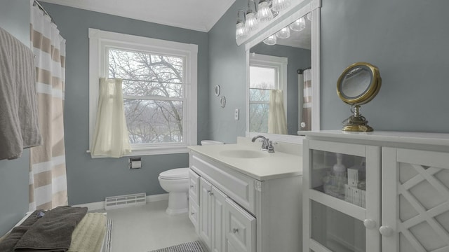 bathroom with vanity, lofted ceiling, and toilet