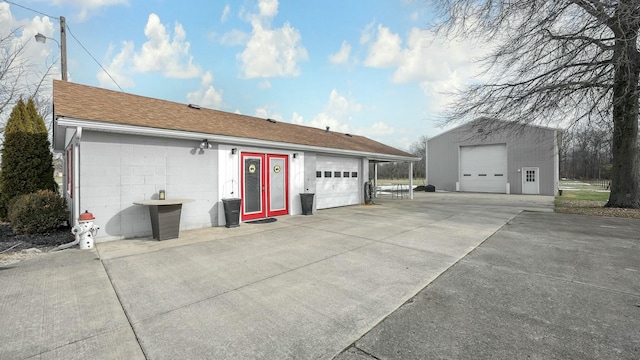 exterior space featuring a garage and an outbuilding