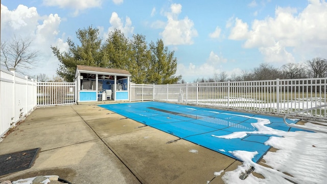 view of pool featuring an outdoor structure and a patio