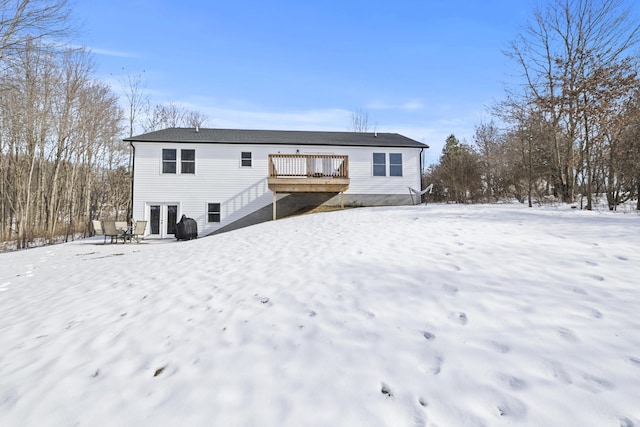 snow covered property featuring a deck