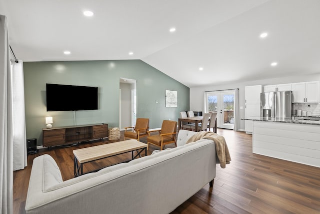 living room featuring french doors, lofted ceiling, and dark hardwood / wood-style flooring