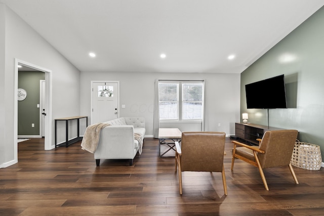 living room with lofted ceiling and dark hardwood / wood-style floors