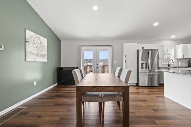 dining space featuring dark hardwood / wood-style floors, a wealth of natural light, and french doors