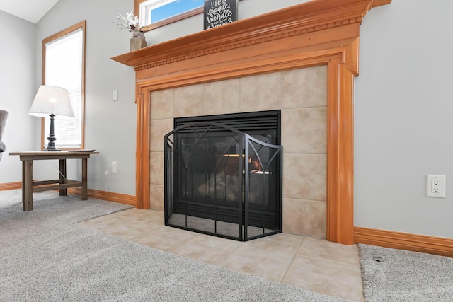 details with a tiled fireplace and carpet