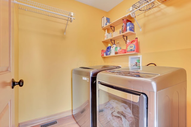 laundry area with separate washer and dryer