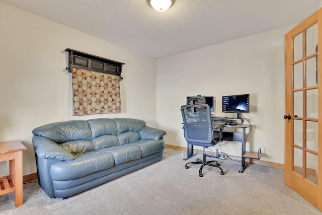 home office featuring french doors, a textured ceiling, and carpet