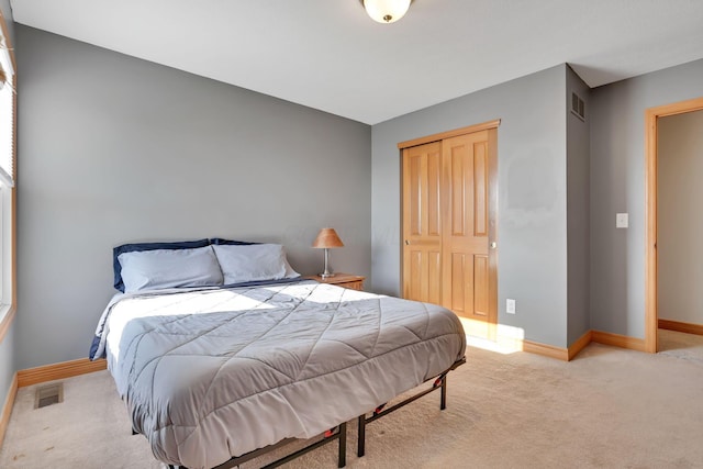 carpeted bedroom featuring a closet