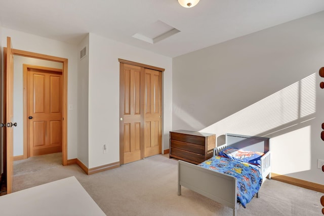 bedroom featuring a closet and light carpet