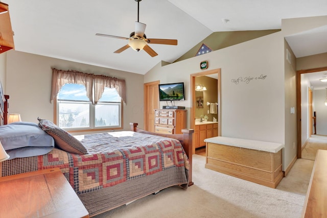 carpeted bedroom featuring lofted ceiling, connected bathroom, and ceiling fan