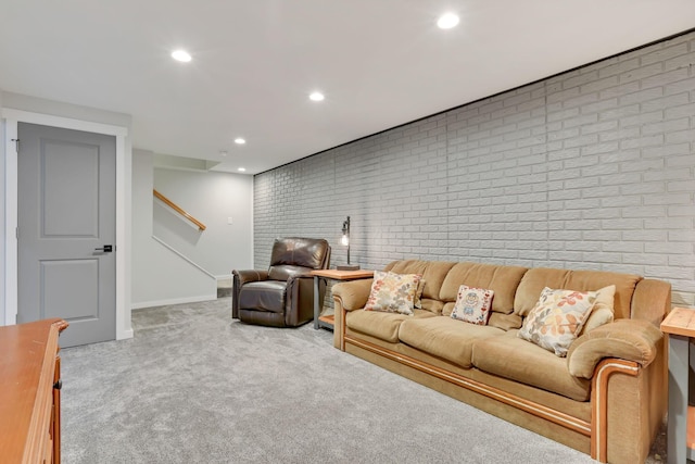 living room featuring brick wall and light colored carpet