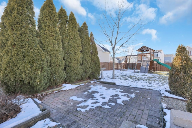 snowy yard with a playground