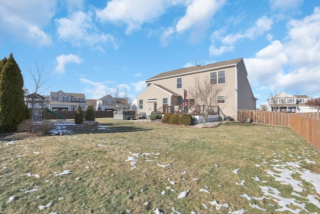 rear view of house featuring a yard