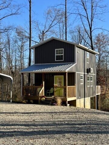 view of front of house with a porch and a carport