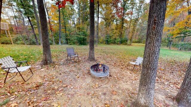 view of yard with an outdoor fire pit