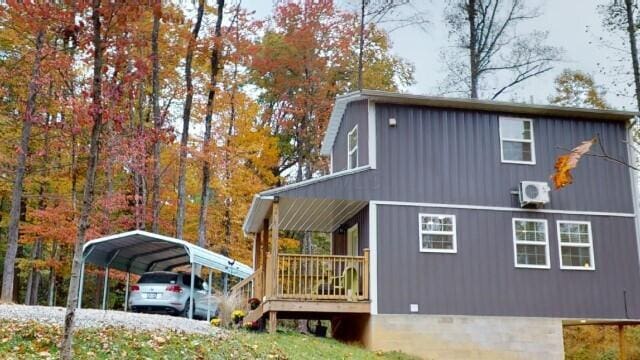 view of property exterior with a carport and ac unit