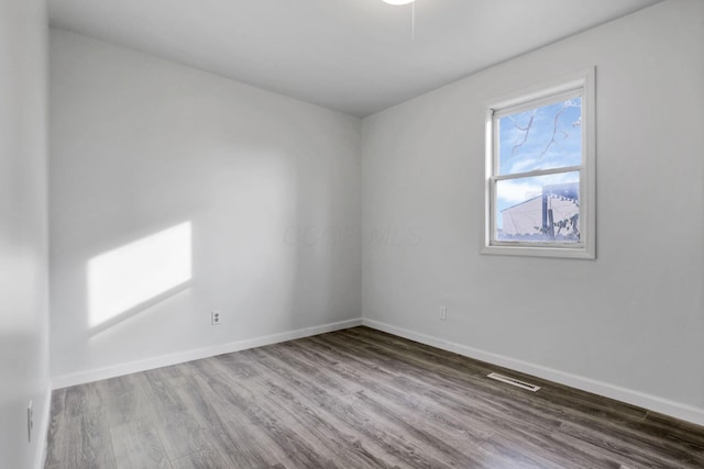 spare room featuring hardwood / wood-style flooring