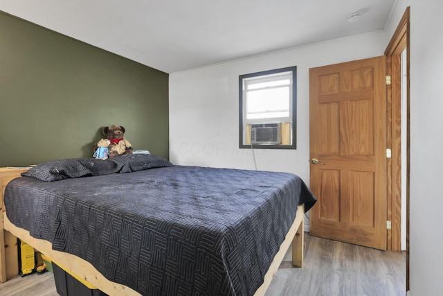 bedroom featuring hardwood / wood-style flooring and cooling unit