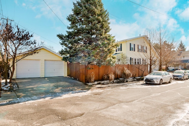 view of front of home with a garage and an outdoor structure